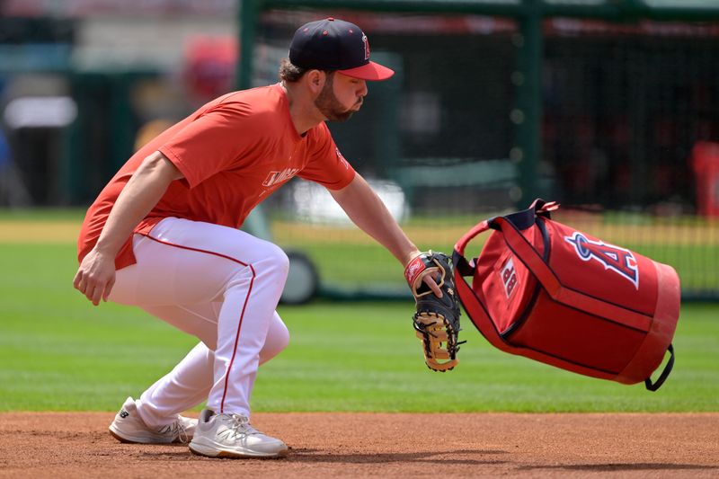 May 26, 2025; Anaheim, California, USA;  Los Angeles Angels first baseman Nolan Schanuel (18) tags an empty baseball bag to simulate a player diving back to the base, prior to the game against the New York Yankees at Angel Stadium. Mandatory Credit: Jayne Kamin-Oncea-Imagn Images