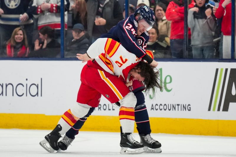 Nov 29, 2024; Columbus, Ohio, USA;  Columbus Blue Jackets right wing Mathieu Olivier (24) fights with Calgary Flames left wing Ryan Lomberg (70) in the second period at Nationwide Arena. Mandatory Credit: Aaron Doster-Imagn Images