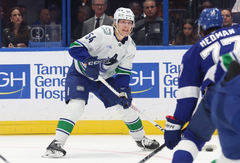 Oct 15, 2024; Tampa, Florida, USA; Vancouver Canucks center Aatu Raty (54) passes the puck against the Tampa Bay Lightning during the second period at Amalie Arena. Mandatory Credit: Kim Klement Neitzel-Imagn Images