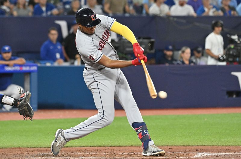 Aug 26, 2023; Toronto, Ontario, CAN;  Cleveland Guardias left fielder Oscar Gonzalez (39) reaches base on an error by Toronto Blue Jays shortstop Santiago Espinal (not pictured) in the sixth inning at Rogers Centre. Mandatory Credit: Dan Hamilton-USA TODAY Sports