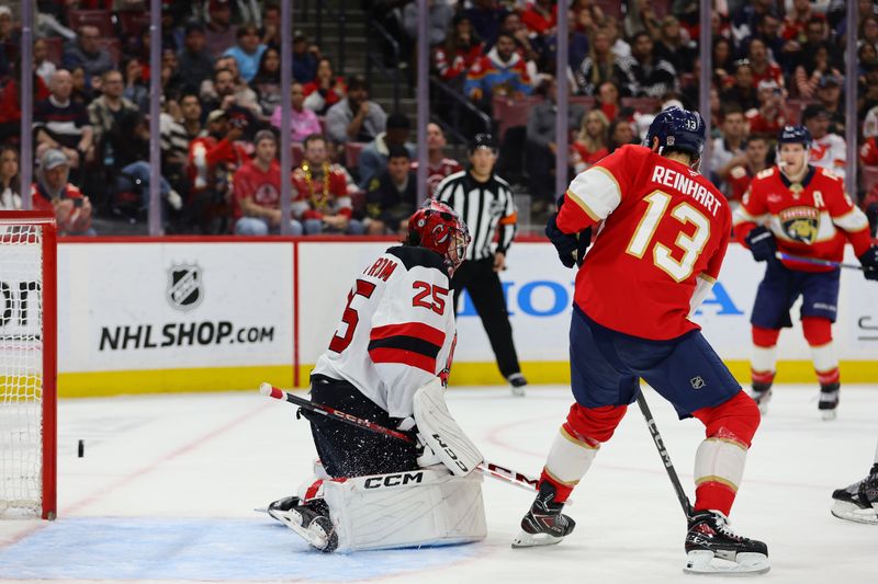 Nov 12, 2024; Sunrise, Florida, USA; Florida Panthers center Sam Reinhart (13) scores against New Jersey Devils goaltender Jacob Markstrom (25) during the second period at Amerant Bank Arena. Mandatory Credit: Sam Navarro-Imagn Images