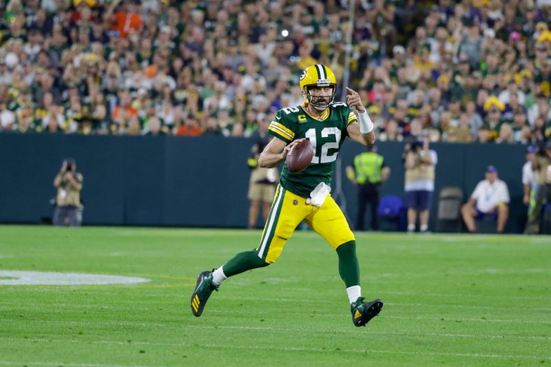 Green Bay Packers quarterback Aaron Rodgers scrambles against the Chicago Bears during an NFL football game Sunday, Sept. 18, 2022, in Green Bay, Wis. (AP Photo/Matt Ludtke)