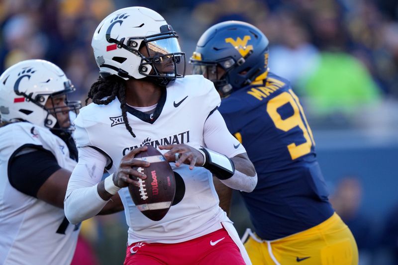 Nov 18, 2023; Morgantown, West Virginia, USA; Cincinnati Bearcats quarterback Emory Jones (5) throws against the West Virginia Mountaineers in the second quarter at Milan Puskar Stadium.  Mandatory Credit: Kareem Elgazzar-USA TODAY Sports