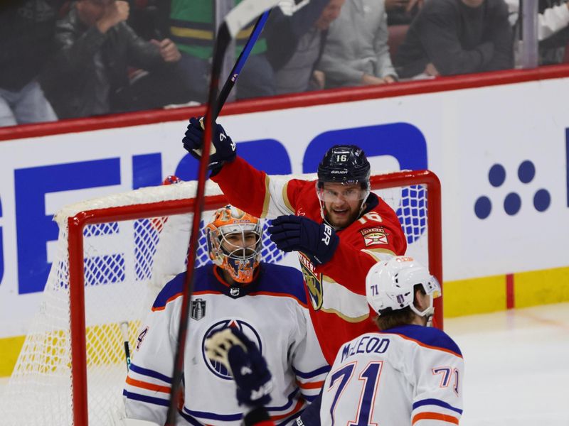 Jun 10, 2024; Sunrise, Florida, USA; Florida Panthers forward Aleksander Barkov (16) celebrates forward Evan Rodrigues (17) goal against Edmonton Oilers goaltender Skinner Stuart (74) during the third period in game two of the 2024 Stanley Cup Final at Amerant Bank Arena. Mandatory Credit: Sam Navarro-USA TODAY Sports