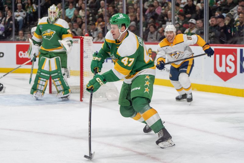 Dec 31, 2024; Saint Paul, Minnesota, USA; Minnesota Wild defenseman Declan Chisholm (47) plays the puck against the Nashville Predators in the third period at Xcel Energy Center. Mandatory Credit: Matt Blewett-Imagn Images