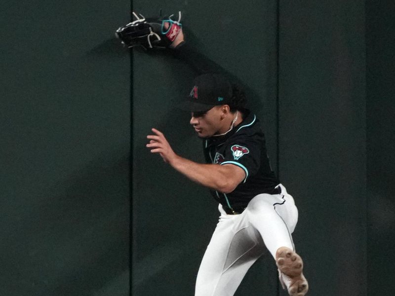 Aug 12, 2024; Phoenix, Arizona, USA; Arizona Diamondbacks outfielder Alek Thomas (5) leaps for the ball against the Colorado Rockies in the first inning at Chase Field. Mandatory Credit: Rick Scuteri-USA TODAY Sports