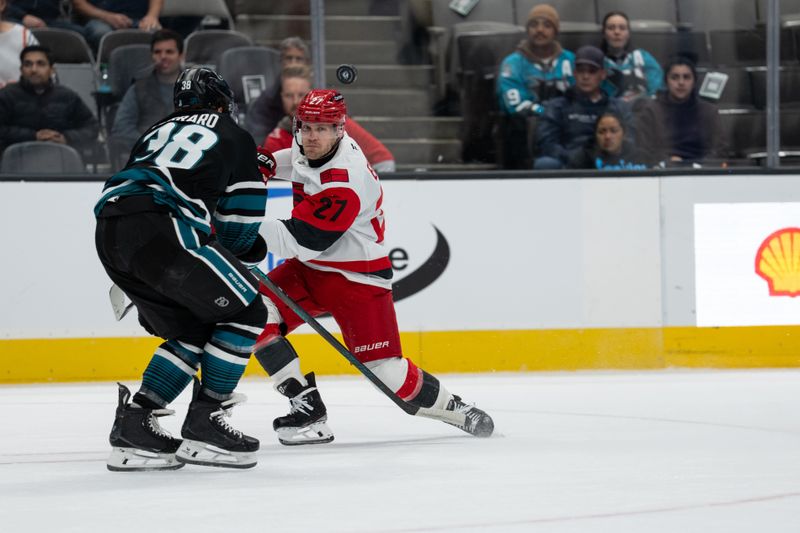 Oct 14, 2025; San Jose, California, USA;  Carolina Hurricanes left wing Nikolaj Ehlers (27) watches the puck during the first period against San Jose Sharks defenseman Mario Ferraro (38) at SAP Center at San Jose. Mandatory Credit: Stan Szeto-Imagn Images