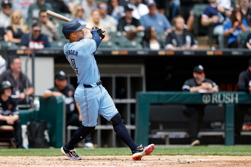 May 27, 2024; Chicago, Illinois, USA; Toronto Blue Jays outfielder George Springer (4) hits a two-run home run against the Chicago White Sox during the second inning at Guaranteed Rate Field. Mandatory Credit: Kamil Krzaczynski-USA TODAY Sports