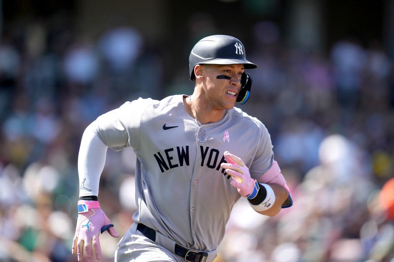 May 11, 2025; West Sacramento, California, USA; New York Yankees right fielder Aaron Judge (99) runs toward first base after hitting a single against the Athletics in the seventh inning at Sutter Health Park. Mandatory Credit: Cary Edmondson-Imagn Images