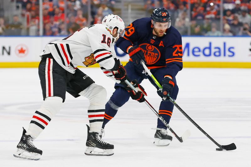 Jan 25, 2024; Edmonton, Alberta, CAN; Chicago Blackhawks forward Jason Dickinson (16) tries to knock the puck away from Edmonton Oilers forward Leon Draisaitl (29) during the first period at Rogers Place. Mandatory Credit: Perry Nelson-USA TODAY Sports