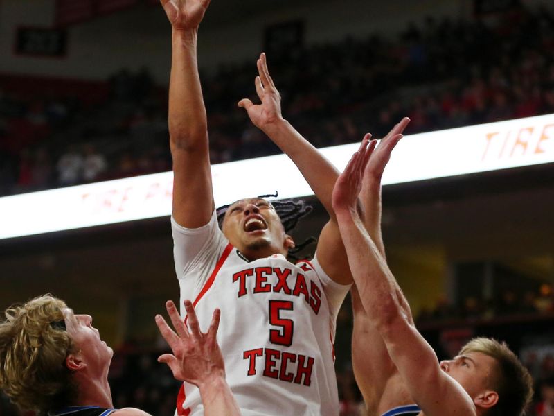 Jan 20, 2024; Lubbock, Texas, USA; Texas Tech Red Raiders guard Darrion Williams (5) goes after a rebound against  Brigham Young Cougars guard Dallin Hall (30) and guard Richie Saunders (15) in the first half at United Supermarkets Arena. Mandatory Credit: Michael C. Johnson-USA TODAY Sports