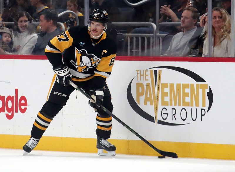 Nov 16, 2024; Pittsburgh, Pennsylvania, USA;  Pittsburgh Penguins center Sidney Crosby (87) moves the puck against the San Jose Sharks during the first period at PPG Paints Arena. Mandatory Credit: Charles LeClaire-Imagn Images