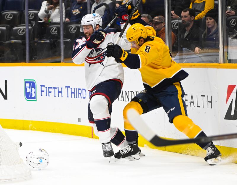 Jan 17, 2023; Nashville, Tennessee, USA;  Nashville Predators center Cody Glass (8) and Columbus Blue Jackets defenseman Vladislav Gavrikov (4) fight for the loose puck during the first period at Bridgestone Arena. Mandatory Credit: Steve Roberts-USA TODAY Sports