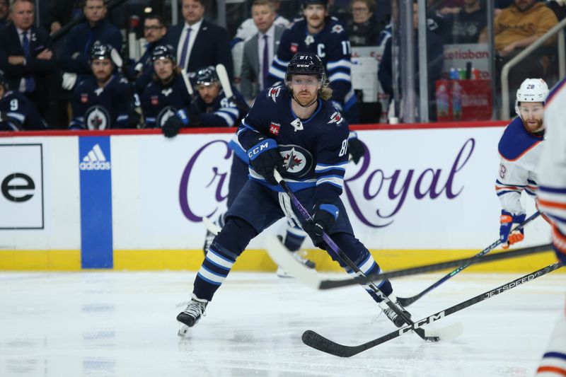 Nov 30, 2023; Winnipeg, Manitoba, CAN; Winnipeg Jets forward Kyle Connor (81) looks to make a pass against the Edmonton Oilers during the second period at Canada Life Centre. Mandatory Credit: Terrence Lee-USA TODAY Sports