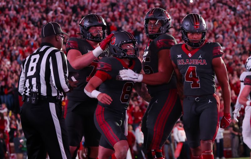 Nov 11, 2023; Norman, Oklahoma, USA;  Oklahoma Sooners quarterback Dillon Gabriel (8) celebrates with teammates after scoring a touchdown during the first quarter against the West Virginia Mountaineers at Gaylord Family-Oklahoma Memorial Stadium. Mandatory Credit: Kevin Jairaj-USA TODAY Sports