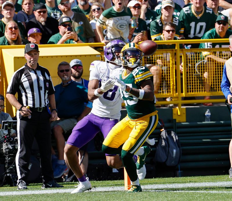 Minnesota Vikings wide receiver Justin Jefferson (18) catches a touchdown against the Green Bay Packers' Keisean Nixon during a NFL football game Sunday, Sept. 29, 2024, in Green Bay, Wis. (AP Photo/Jeffrey Phelps