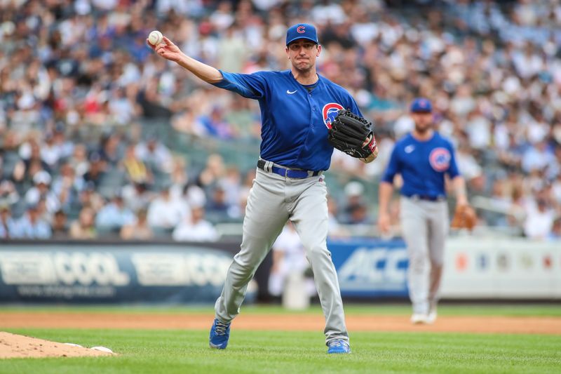 Jul 9, 2023; Bronx, New York, USA;  Chicago Cubs starting pitcher Kyle Hendricks (28) throws a runner out at first base in the fourth inning against the New York Yankees at Yankee Stadium. Mandatory Credit: Wendell Cruz-USA TODAY Sports