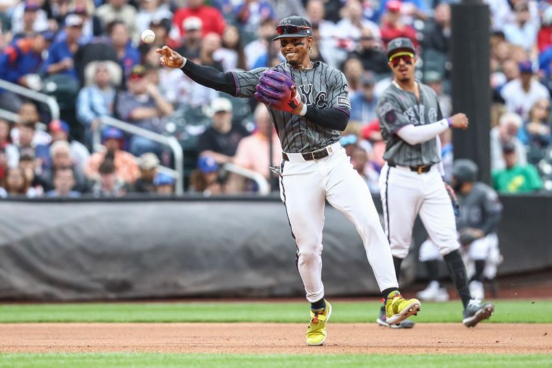 Sep 7, 2024; New York City, New York, USA;  New York Mets shortstop Francisco Lindor (12) throws a runner out at first base in the first inning against the Cincinnati Reds at Citi Field. Mandatory Credit: Wendell Cruz-Imagn Images