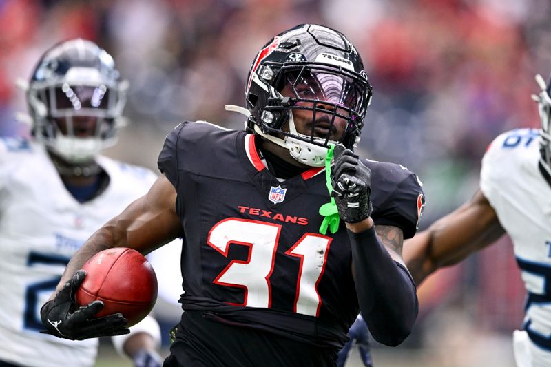 Houston Texans running back Dameon Pierce (31) runs the bal against the Tennessee Titans in the first quarter during an NFL football game, Sunday, Nov 24, 2024 in Houston. (AP Photo/Maria Lysaker)