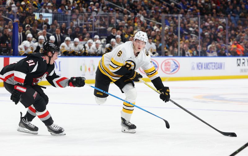Dec 27, 2025; Buffalo, New York, USA;  Boston Bruins defenseman Mason Lohrei (6) looks to make a pass as Buffalo Sabres right wing Josh Doan (91) defends during the first period at KeyBank Center. Mandatory Credit: Timothy T. Ludwig-Imagn Images