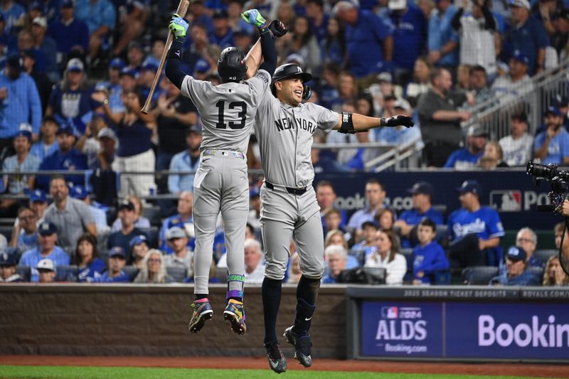 Oct 9, 2024; Kansas City, Missouri, USA; New York Yankees designated hitter Giancarlo Stanton (27) celebrates with New York Yankees third base Jazz Chisholm Jr. (13) after the hiyting a home run in the eighth inning against the Kansas City Royals during game three of the NLDS for the 2024 MLB Playoffs at Kauffman Stadium. Mandatory Credit: Peter Aiken-Imagn Images