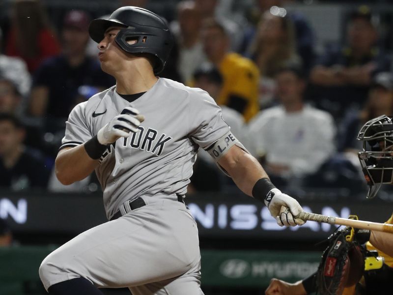 Sep 16, 2023; Pittsburgh, Pennsylvania, USA; New York Yankees shortstop Anthony Volpe (11) hits a single against the Pittsburgh Pirates during the ninth inning at PNC Park. New York won 6-3. Mandatory Credit: Charles LeClaire-USA TODAY Sports