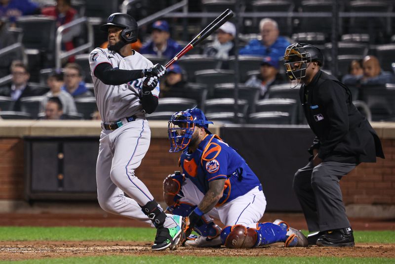 Sep 27, 2023; New York, NY, USA; Miami Marlins left fielder Bryan De La Cruz (14) hits an RBI single during the ninth inning against the New York Mets at Citi Field.  Mandatory Credit: Vincent Carchietta-USA TODAY Sports