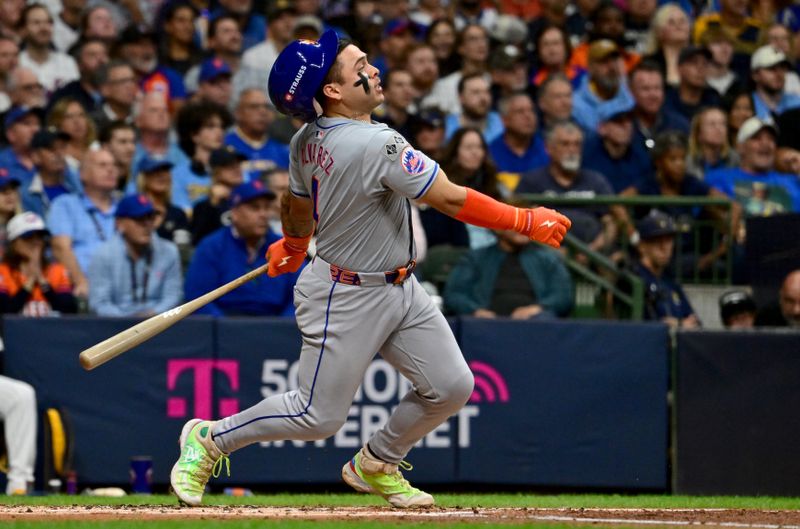 Oct 2, 2024; Milwaukee, Wisconsin, USA; New York Mets catcher Francisco Alvarez (4) hits a RBI single during the second inning in game two of the Wildcard round for the 2024 MLB Playoffs against the Milwaukee Brewers at American Family Field. Mandatory Credit: Benny Sieu-Imagn Images