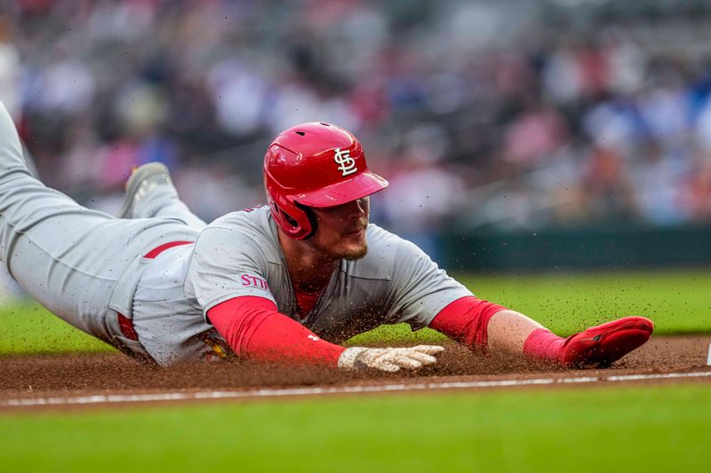 Sep 6, 2023; Cumberland, Georgia, USA; St. Louis Cardinals second baseman Nolan Gorman (16) slides into third base against the Atlanta Braves during the first inning at Truist Park. Mandatory Credit: Dale Zanine-USA TODAY Sports