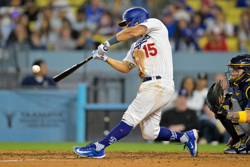 Aug 17, 2023; Los Angeles, California, USA;  Los Angeles Dodgers catcher Austin Barnes (15) hits a solo home run in the eighth inning against the Milwaukee Brewers at Dodger Stadium. Mandatory Credit: Jayne Kamin-Oncea-USA TODAY Sports