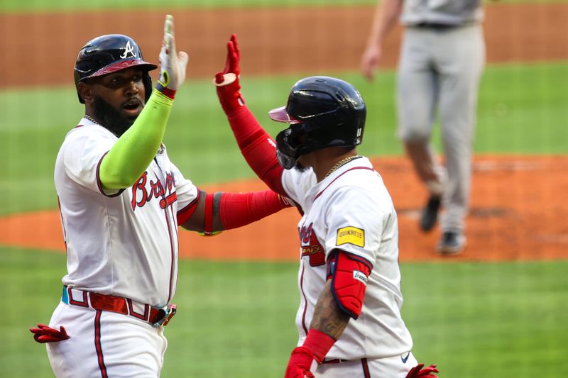 May 8, 2024; Atlanta, Georgia, USA; Atlanta Braves designated hitter Marcell Ozuna (20) celebrates after a three-run home run with shortstop Orlando Arcia (11) against the Boston Red Sox in the first inning at Truist Park. Mandatory Credit: Brett Davis-USA TODAY Sports
