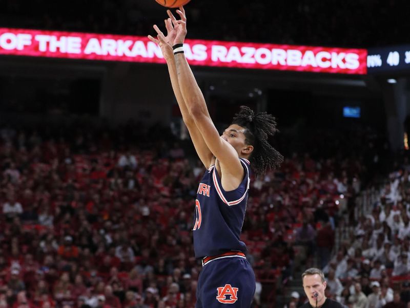 Jan 6, 2024; Fayetteville, Arkansas, USA; Auburn Tigers guard Chad Baker-Mazara (10) shoots a three point shot in the first half against the Arkansas Razorbacks at Bud Walton Arena. Mandatory Credit: Nelson Chenault-USA TODAY Sports