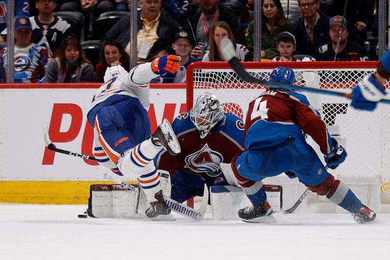 Apr 11, 2023; Denver, Colorado, USA; Edmonton Oilers center Connor McDavid (97) gets tripped up by Colorado Avalanche defenseman Bowen Byram (4) and goaltender Alexandar Georgiev (40) defends in overtime at Ball Arena. Mandatory Credit: Isaiah J. Downing-USA TODAY Sports