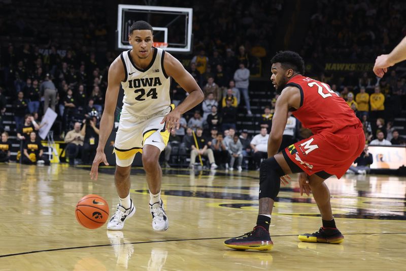 Jan 15, 2023; Iowa City, Iowa, USA; Maryland Terrapins forward Donta Scott (24) defends the dribble from Iowa Hawkeyes forward Kris Murray (24) at Carver-Hawkeye Arena.  The Hawkeyes beat the Terrapins 81-67. Mandatory Credit: Reese Strickland-USA TODAY Sports