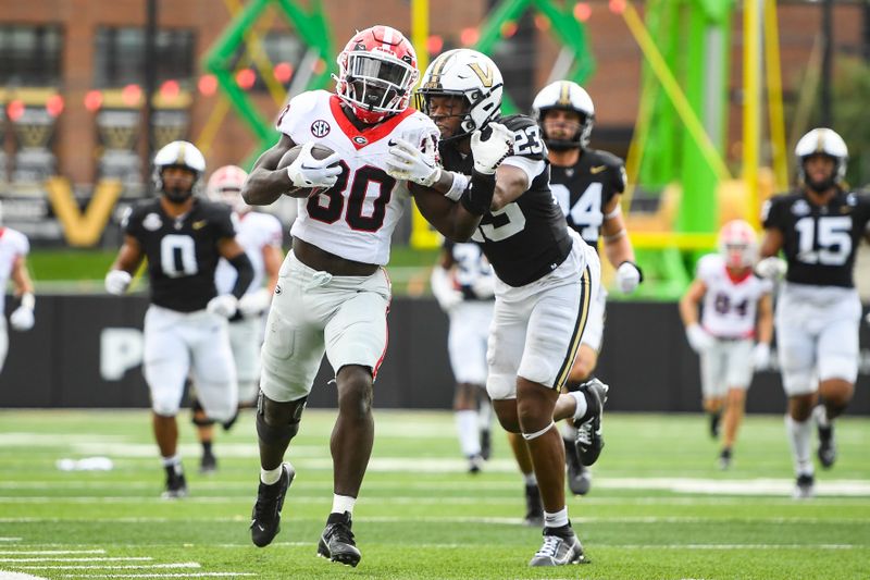 Oct 14, 2023; Nashville, Tennessee, USA;  Georgia Bulldogs running back Daijun Edwards (30) drags Vanderbilt Commodores defensive back Jaylen Mahoney (23) during the second half at FirstBank Stadium. Mandatory Credit: Steve Roberts-USA TODAY Sports