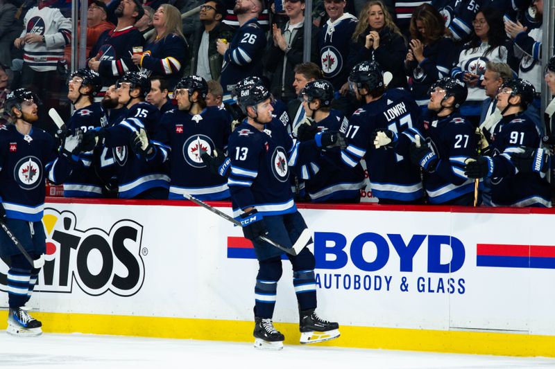 Feb 20, 2024; Winnipeg, Manitoba, CAN; Winnipeg Jets forward Gabriel Vilardi (13) is congratulated by his team mates on his goal against the Minnesota Wild during the first period at Canada Life Centre. Mandatory Credit: Terrence Lee-USA TODAY Sports