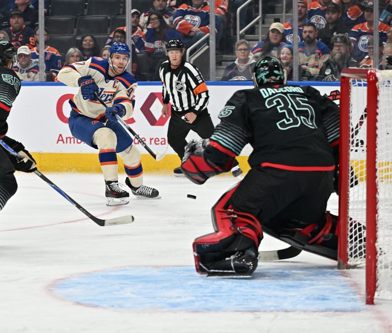 Dec 4, 2025; Edmonton, Alberta, CAN; Edmonton Oilers center Connor McDavid (97) takes a shot on Kraken goalie Joey Daccord (35) during the first period at Rogers Place. Mandatory Credit: Walter Tychnowicz-Imagn Images
