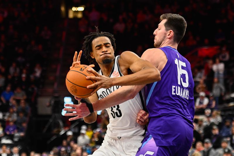 SALT LAKE CITY, UTAH - JANUARY 12: Nic Claxton #33 of the Brooklyn Nets drives into Drew Eubanks #15 of the Utah Jazz during overtime a game at Delta Center on January 12, 2025 in Salt Lake City, Utah. NOTE TO USER: User expressly acknowledges and agrees that, by downloading and or using this photograph, User is consenting to the terms and conditions of the Getty Images License Agreement.   (Photo by Alex Goodlett/Getty Images)