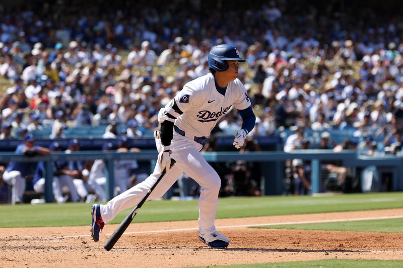 Aug 11, 2024; Los Angeles, California, USA;  Los Angeles Dodgers designated hitter Shohei Ohtani (17) hits a triple during the sixth inning against the Pittsburgh Pirates at Dodger Stadium. Mandatory Credit: Kiyoshi Mio-USA TODAY Sports