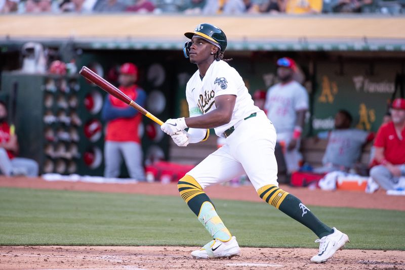 Jul 2, 2024; Oakland, California, USA; Oakland Athletics outfielder Lawrence Butler (4) hits a home run against the Los Angeles Angels during the fourth inning at Oakland-Alameda County Coliseum. Mandatory Credit: Ed Szczepanski-USA TODAY Sports