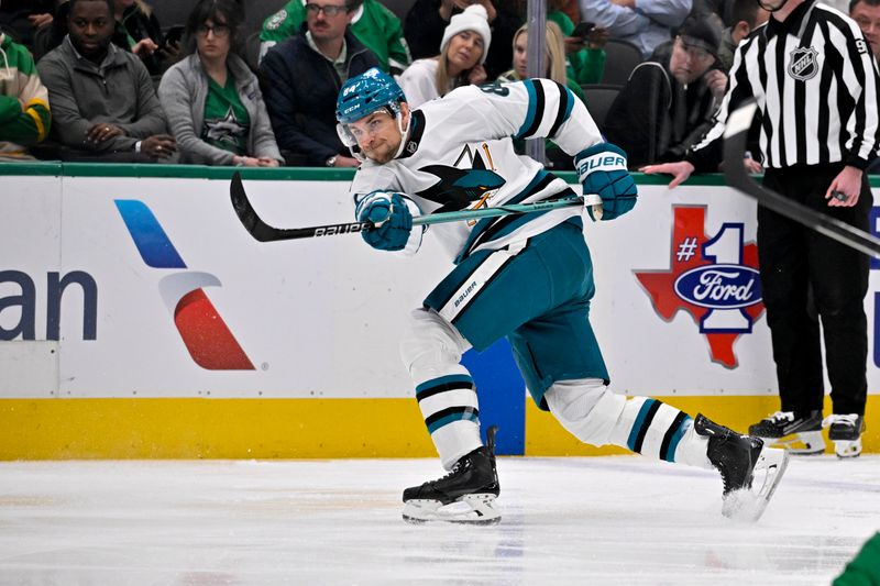 Nov 20, 2024; Dallas, Texas, USA; San Jose Sharks defenseman Jan Rutta (84) shoots the puck in the Dallas Stars zone during the first period at the American Airlines Center. Mandatory Credit: Jerome Miron-Imagn Images