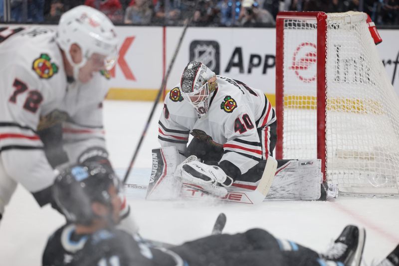 Feb 25, 2025; Salt Lake City, Utah, USA; Chicago Blackhawks goaltender Arvid Soderblom (40) covers the puck from a shot by the Utah Hockey Club during the first period at Delta Center. Mandatory Credit: Rob Gray-Imagn Images