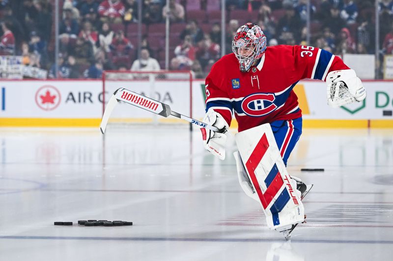 Jan 18, 2025; Montreal, Quebec, CAN; Montreal Canadiens goalie Sam Montembeault (35) jumps first on the ice during warm-up before the game against the Toronto Maple Leafs at Bell Centre. Mandatory Credit: David Kirouac-Imagn Images