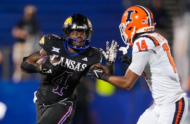Sep 8, 2023; Lawrence, Kansas, USA; Kansas Jayhawks running back Devin Neal (4) runs the ball against Illinois Fighting Illini defensive back Xavier Scott (14) during the second half at David Booth Kansas Memorial Stadium. Mandatory Credit: Jay Biggerstaff-USA TODAY Sports