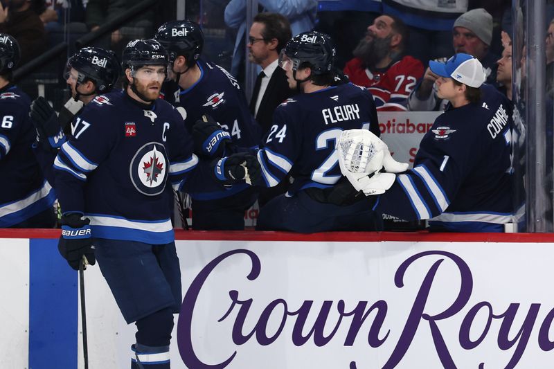 Dec 14, 2024; Winnipeg, Manitoba, CAN; Winnipeg Jets center Adam Lowry (17) celebrates his first period goal against the Montreal Canadiens at Canada Life Centre. Mandatory Credit: James Carey Lauder-Imagn Images