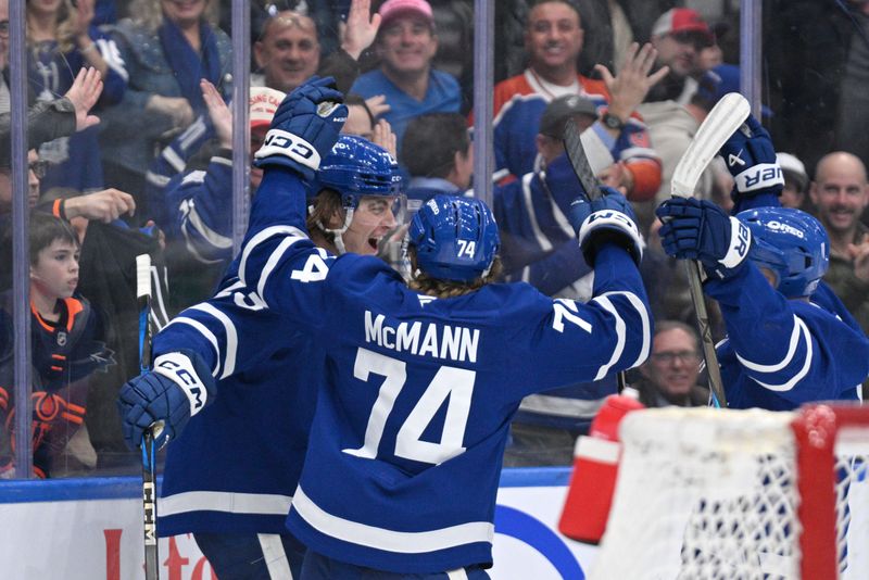 Nov 16, 2024; Toronto, Ontario, CAN;  Toronto Maple Leafs forward Matthew Knies (23) celebrates with forward Bobby McMann (74) and forward Max Domi (11) after scoring against the Edmonton Oilers in the third period at Scotiabank Arena. Mandatory Credit: Dan Hamilton-Imagn Images