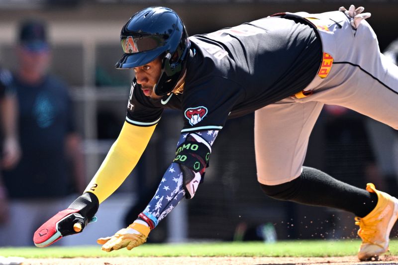 Jul 7, 2024; San Diego, California, USA; Arizona Diamondbacks shortstop Geraldo Perdomo (2) dives home to score a run on a three-RBI double hit by third baseman Eugenio Suarez (not pictured) during the ninth inning against the San Diego Padres at Petco Park. Mandatory Credit: Orlando Ramirez-USA TODAY Sports