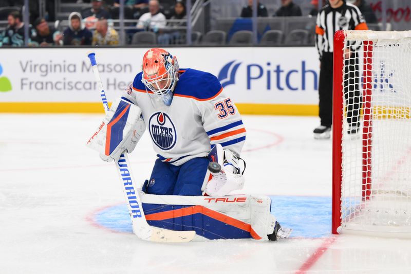 Oct 2, 2024; Seattle, Washington, USA; Edmonton Oilers goaltender Olivier Rodrigue (35) blocks a goal shot against the Seattle Kraken during the third period at Climate Pledge Arena. Mandatory Credit: Steven Bisig-Imagn Images