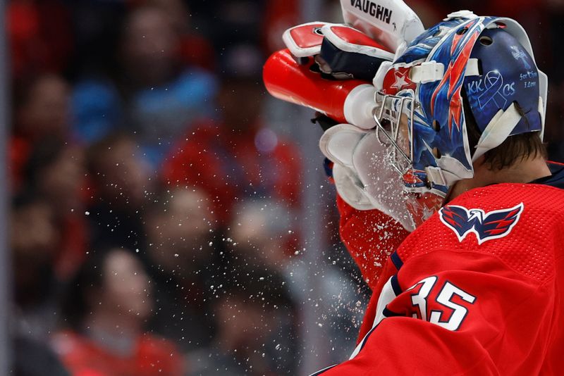 Feb 11, 2024; Washington, District of Columbia, USA; Washington Capitals goaltender Darcy Kuemper (35) squirts his face with water during a stoppage in play against the Vancouver Canucks in the third period at Capital One Arena. Mandatory Credit: Geoff Burke-USA TODAY Sports