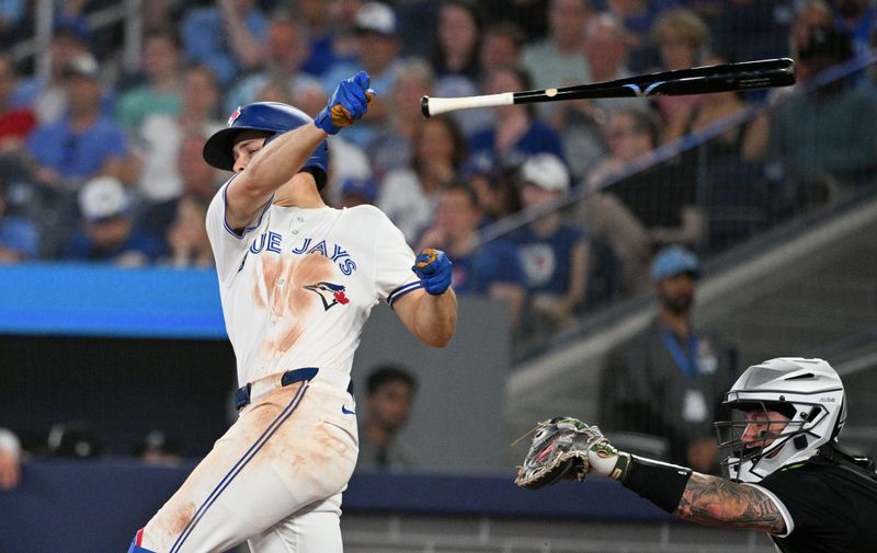 May 21, 2024; Toronto, Ontario, CAN;  Toronto Blue Jays third baseman Ernie Clement (28) loses his grip on his bat swinging at a pitch against the Chicago White Sox in the eighth inning at Rogers Centre. Mandatory Credit: Dan Hamilton-USA TODAY Sports